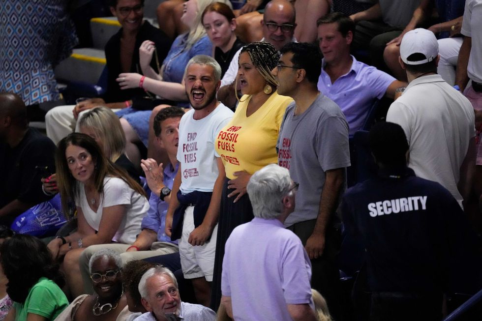 Protesters demonstrate at a match between Coco Gauff, of the United States, and Karolina Muchova, of the Czech Republic, during the women