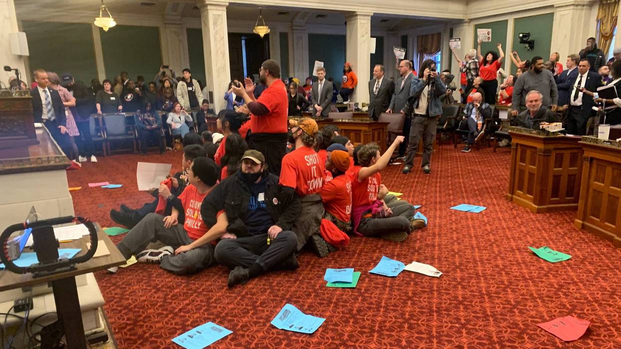 Protesters disrupt City Council before their votes on a package of legislation enabling the construction of a new Market East 76ers arena.