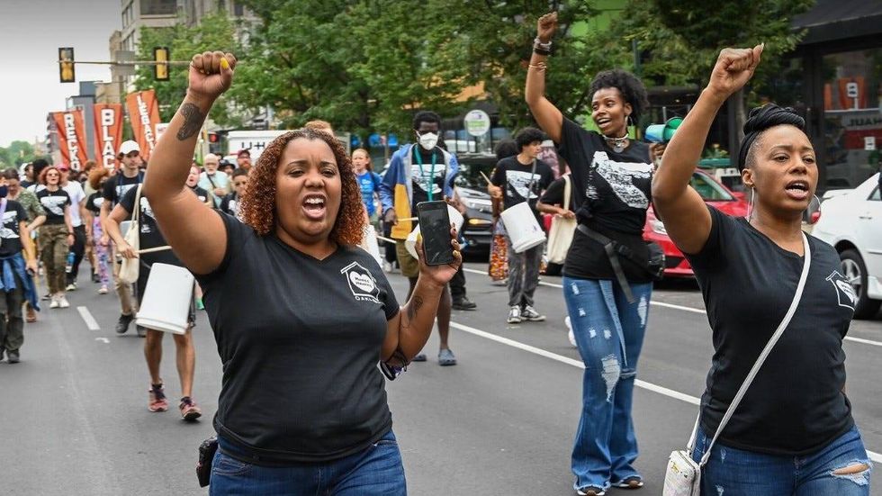 Protesters during the Save the UC Townhomes march on Saturday in University City.