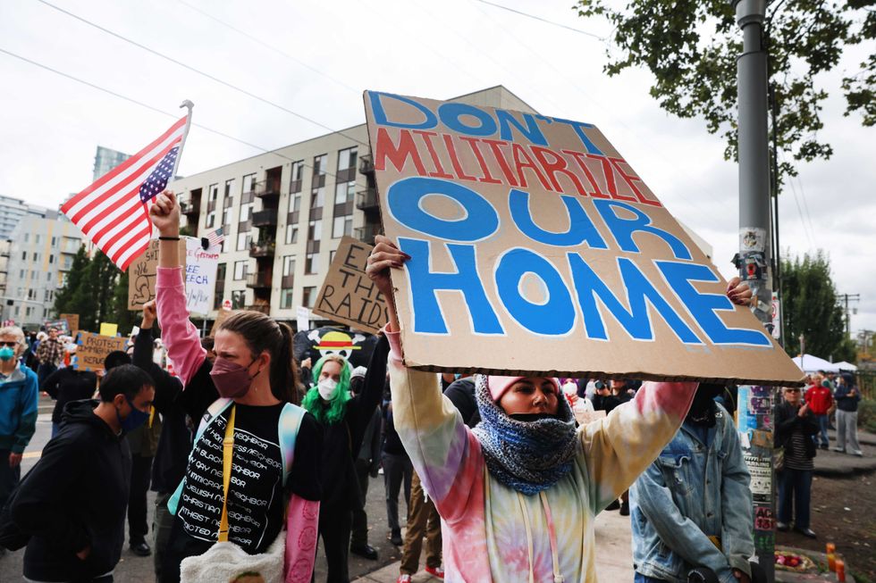 Protesters gather outside of a downtown U.S. Immigration and Customs Enforcement (ICE) facility on October 04, 2025 in Portland, Oregon.