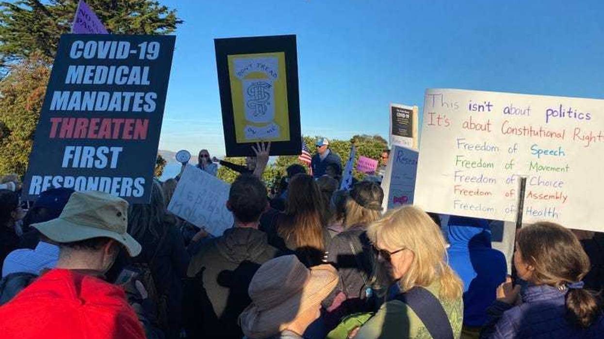 Protesters hold signs in a demonstration against COVID-19 vaccine mandates at the Golden Gate Bridge.