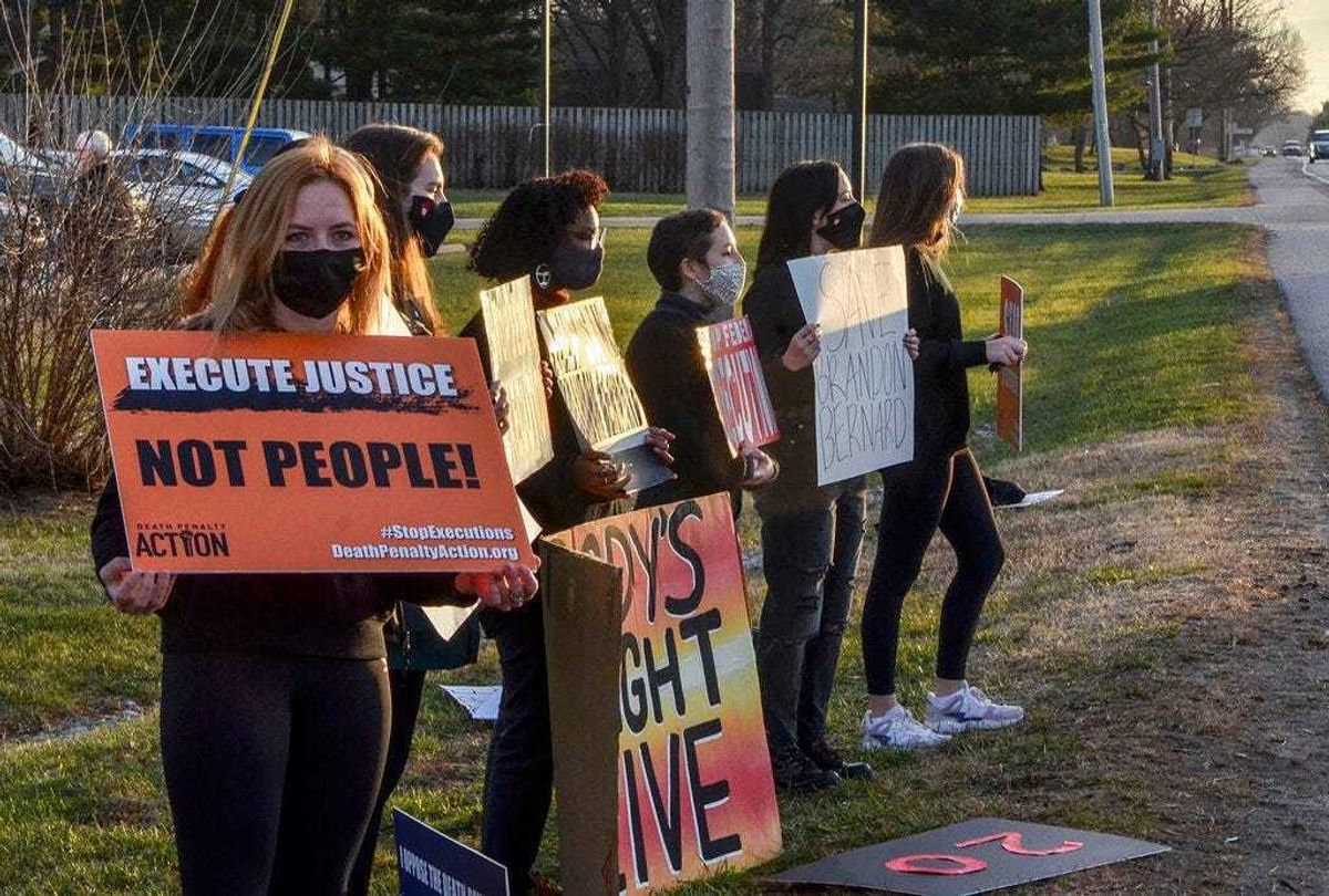 Protesters line Prairieton Road across from the Federal Execution Chamber, Thursday, Dec. 10, 2020 in Terre Haute, Ind.