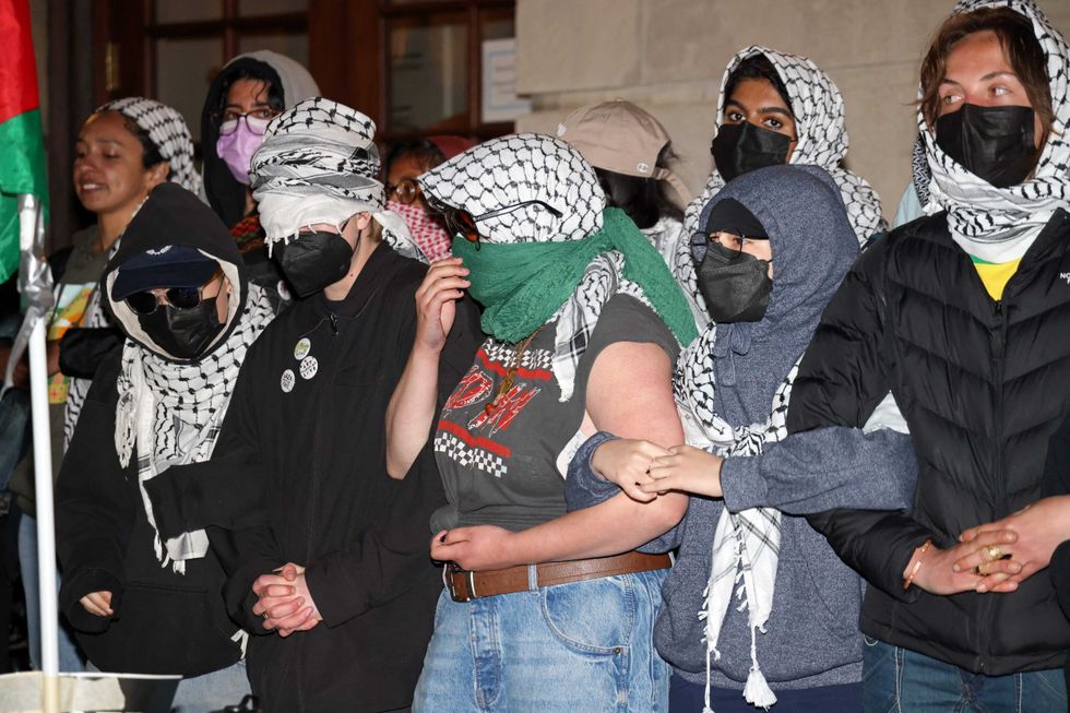 Protesters lock arms at the entrance to Hamilton Hall on the campus of Columbia University, on April 30, 2024.