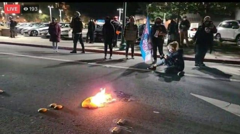 Protesters set items on fire at a rowdy protest in downtown Walnut Creek on Saturday night.