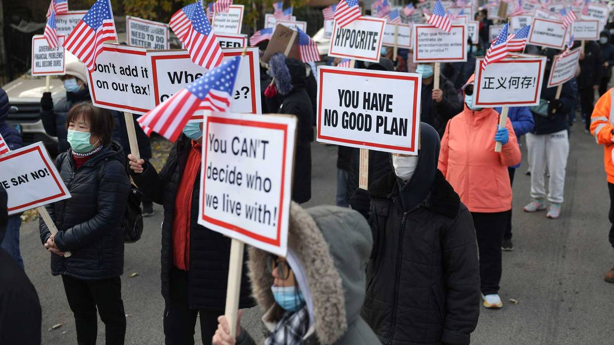 Protesters walk down West 38th Street during a protest in Brighton Park on Nov. 10, 2023 against a proposed migrant camp at 38th Street and California Avenue.