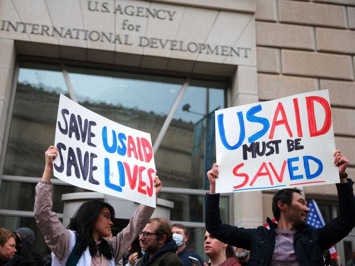 Protestors gather outside of USAID headquarters on February 03, 2025 in Washington, DC. Elon Musk, tech billionaire and head of the Department of Government Efficiency (DOGE), said in a social media post that he and U.S. President Donald Trump will shut down the foreign assistance agency.