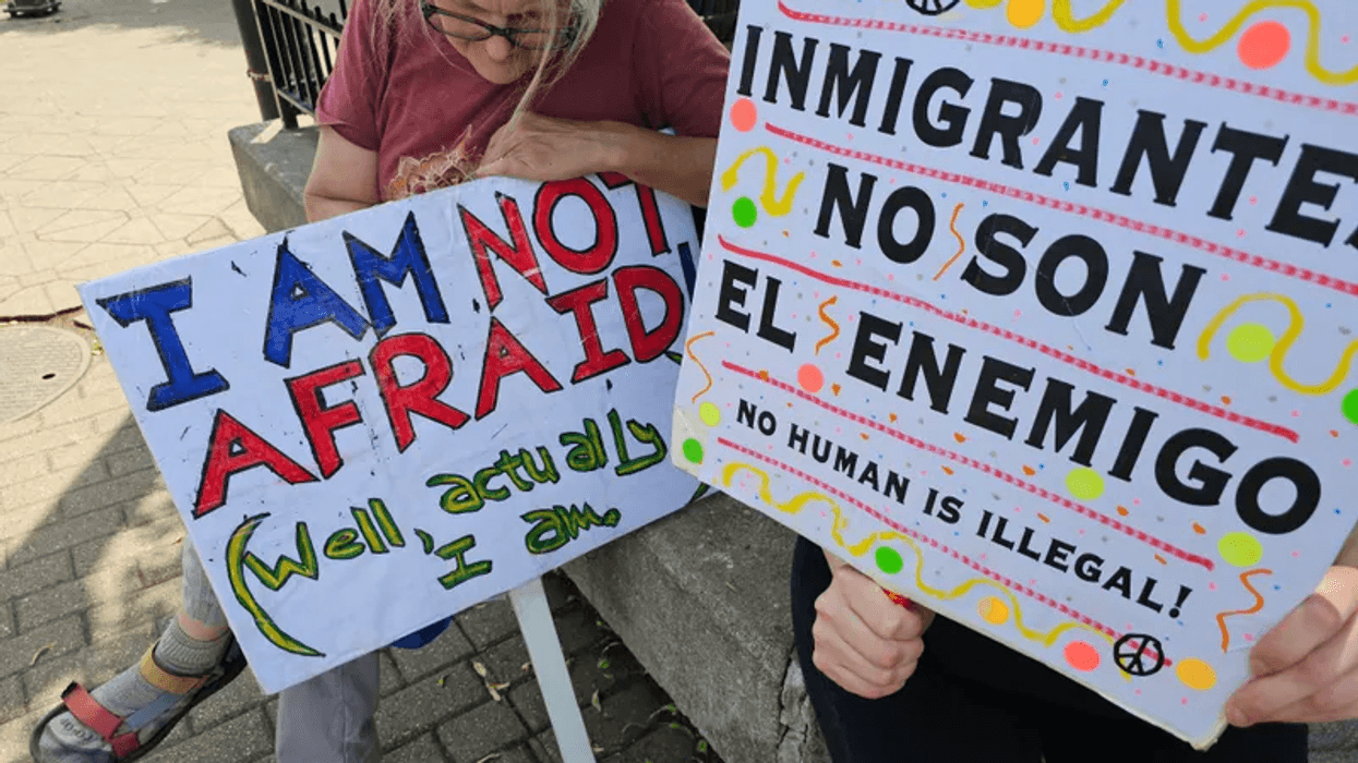Protestors hold up signs on Sunday, June 8, 2025, advocating for local immigrants detained by ICE.