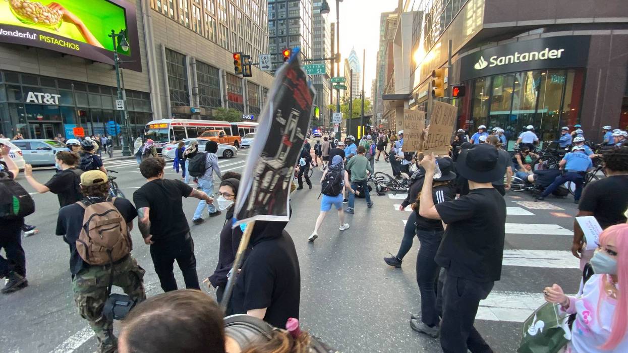 Protestors march in a rally against ICE raids earlier this week that ended with 15 people arrested.