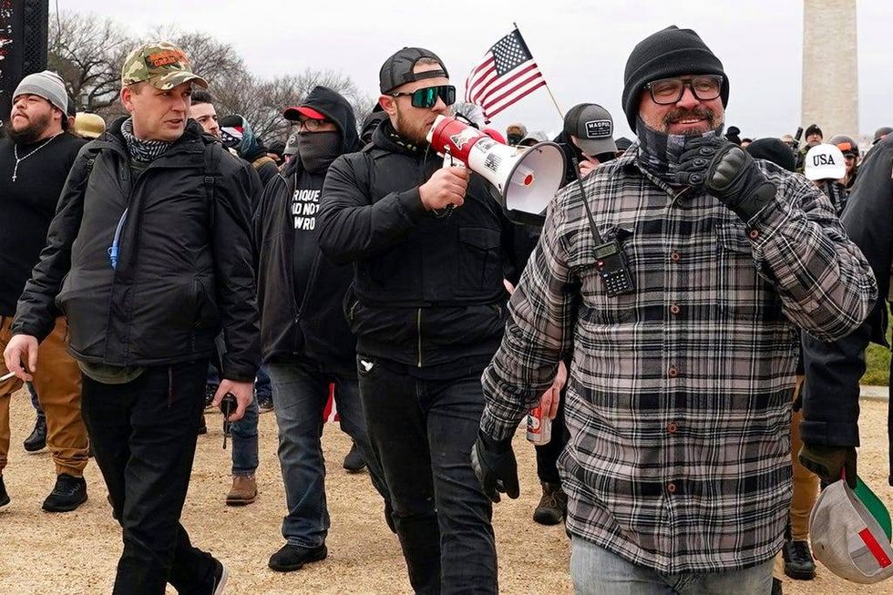 Proud Boys members including Zachary Rehl, left, Ethan Nordean, center, and Joseph Biggs, walk toward the U.S. Capitol in Washington, in support of President Donald Trump on Jan. 6, 2021.