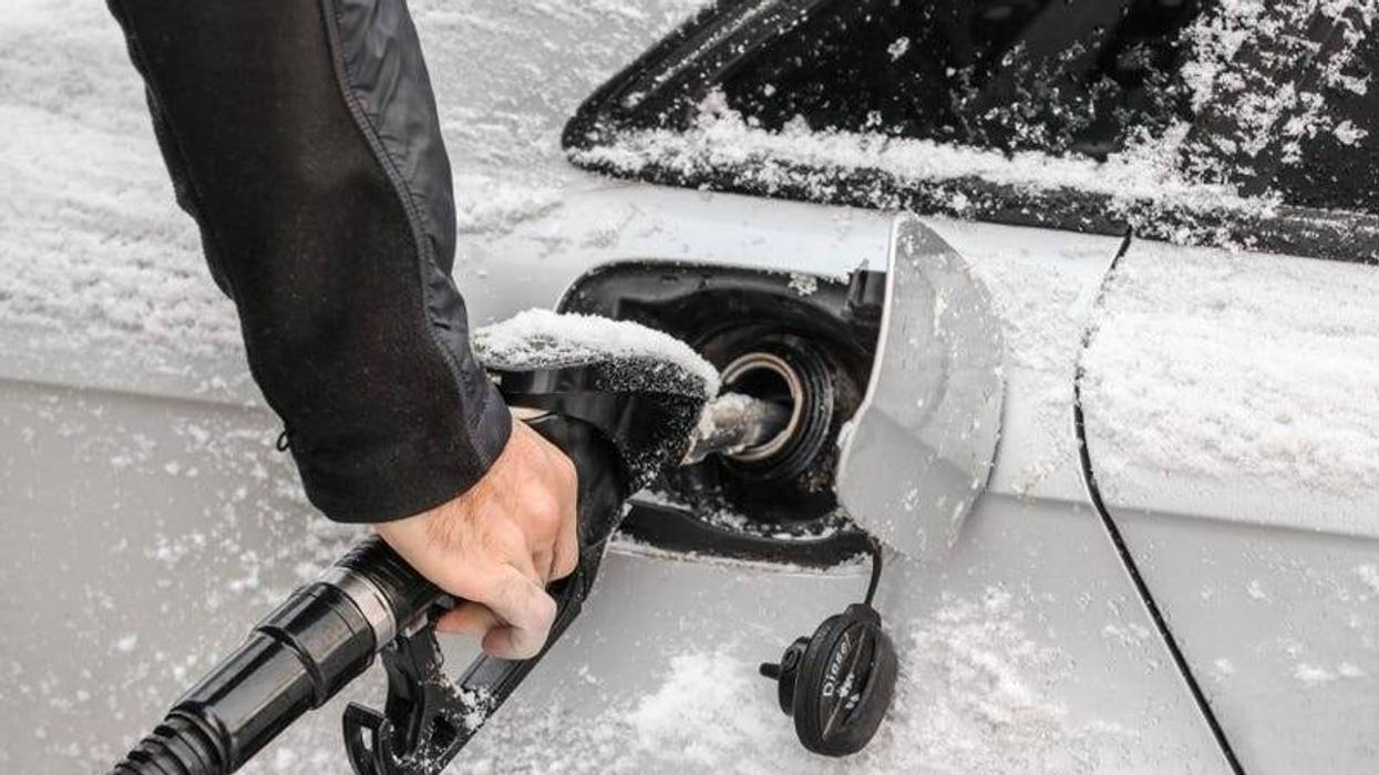Pumping gas into snow-dusted car