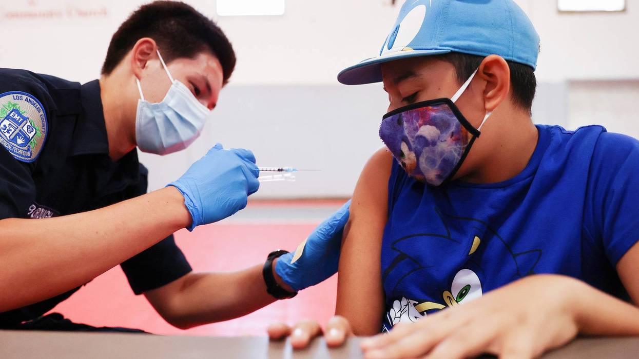 Quentin Scarborough administers a vaccine dose to student Nathan Alex Perez during a pop-up COVID-19 vaccination clinic at James Jordan Middle School on July 6, 2021 in Winnetka, California.
