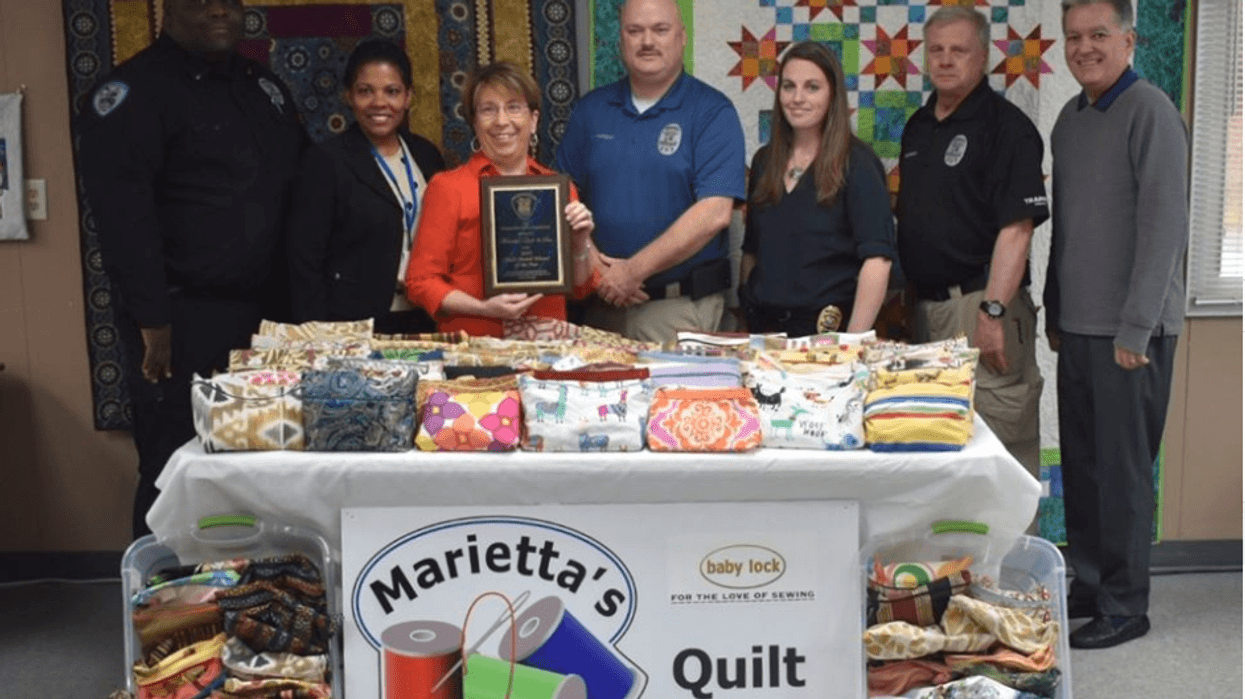 Quilt & Sew receives Chief's Award Winner of the Year. Photo: L-R, Simpsonville PD Lt. Timmie L. Williams, Victims Advocate Milena Banquez, Quilt & Sew co-owner Marietta Louk, Chief Mike Hanshaw, Cpt. Cheryl Manley, Lt Russ Holthaus and Mayor Shewmaker