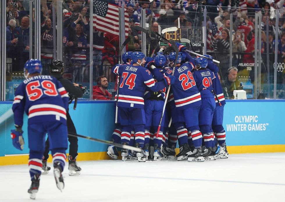 Quinn Hughes #43 of Team United States celebrates with teammates after scoring a goal in overtime during the Men