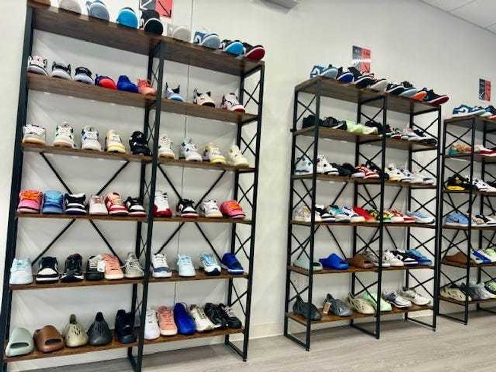 Racks of shoes show off the thrifting "sneaker culture" that has been built on the success of "Air Jordans".