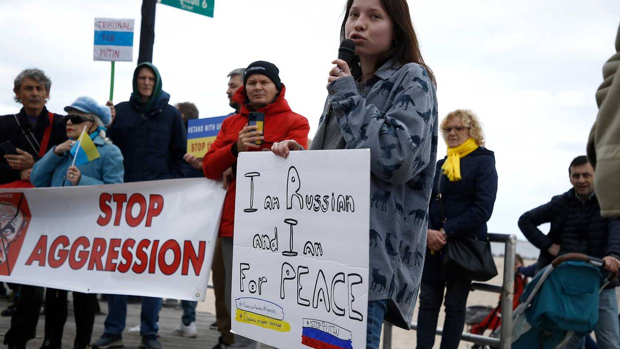 Rally participants listen to a Russian speaker denounce the war in the Ukraine on March 20, 2022 in the Brighton Beach section of the Brooklyn borough of New York City. As the Russian invasion of Ukraine escalates with intense shelling and targeting of civilians, many Russians have fled to neighboring countries for fear of political retribution and as a way to protest the war.
