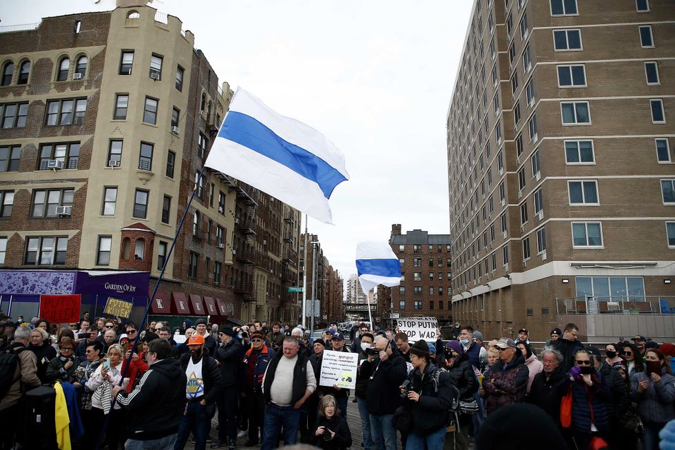 Rally participants listen to mostly Russian speakers denounce the war in the Ukraine on March 20, 2022 in the Brighton Beach section of the Brooklyn borough of New York City. As the Russian invasion of Ukraine escalates with intense shelling and targeting of civilians, many Russians have fled to neighboring countries for fear of political retribution and as a way to protest the war.