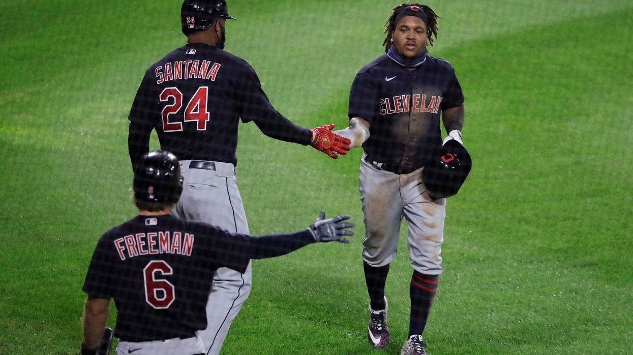 Ramirez gets congratulated after scoring on squeeze play