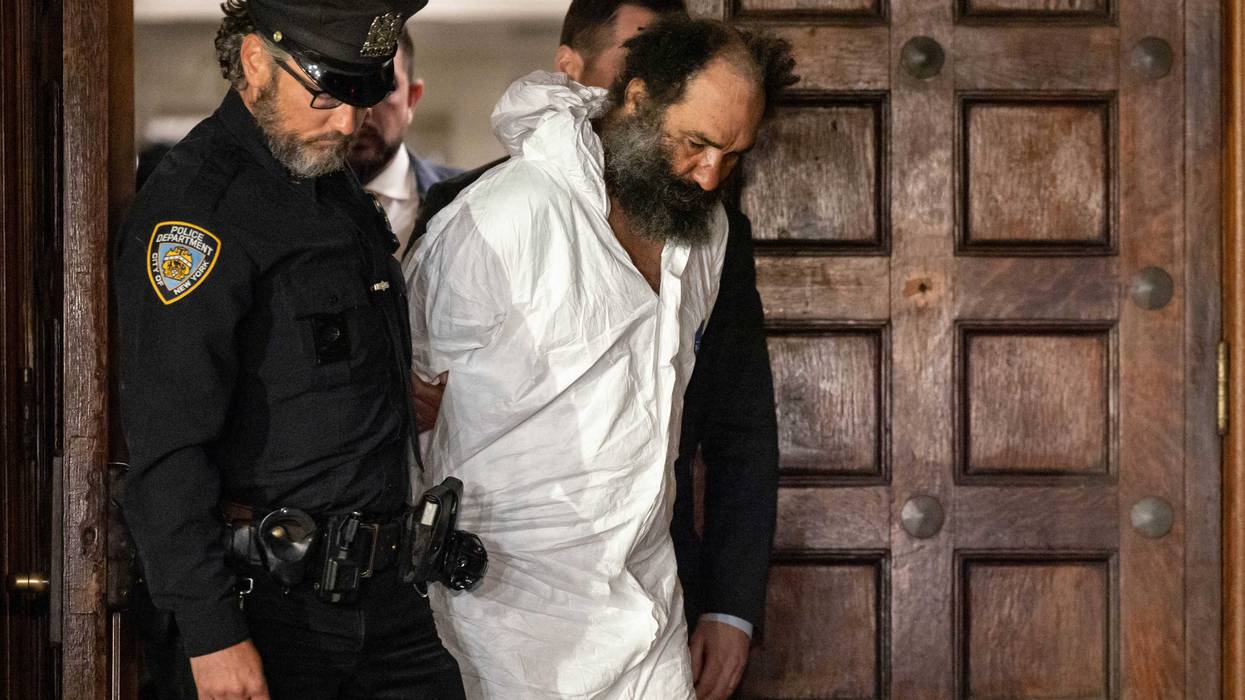 Ramon Rivera, a suspect arrested after multiple people were stabbed early Monday, is escorted out by NYPD officers at the NYPD 10th Precinct in New York, Monday, Nov. 18, 2024