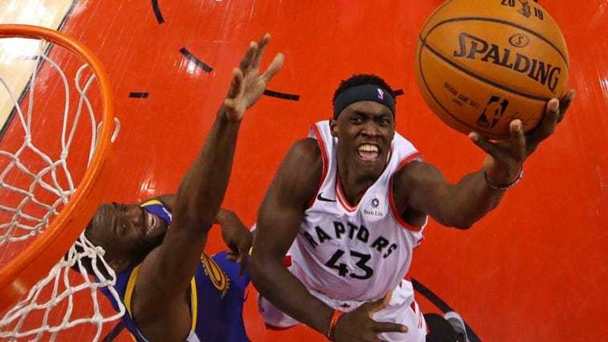 Raptors forward Pascal Siakam shoots the ball against Warriors forward Draymond Green in Game 1 of the NBA Finals on May 30, 2019, in Toronto.