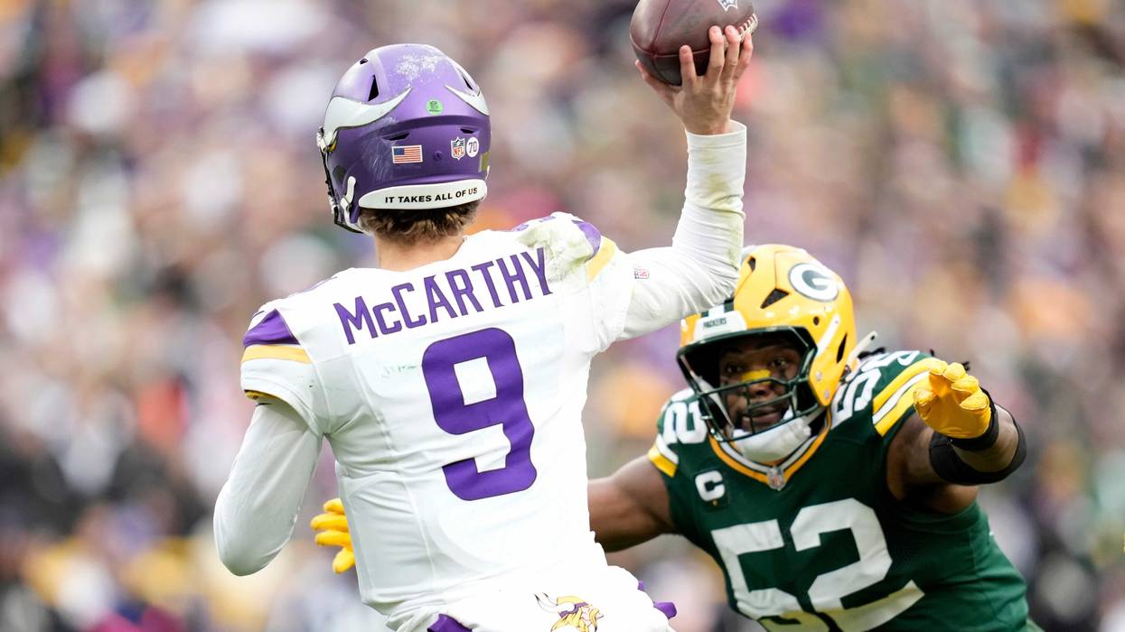Rashan Gary #52 of the Green Bay Packers pressures J.J. McCarthy #9 of the Minnesota Vikings during the second half at Lambeau Field on November 23, 2025 in Green Bay, Wisconsin. The pass from J.J. McCarthy was intercepted by Green Bay.