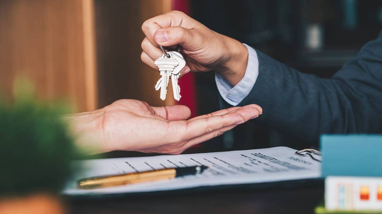 real estate agent handing over house keys