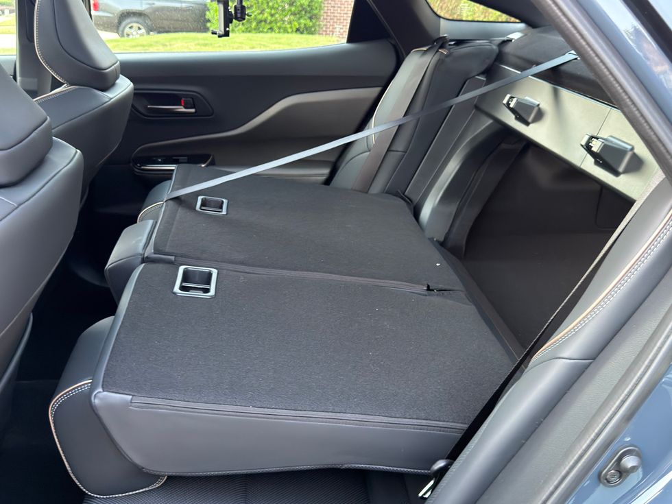 Rear car seats folded down to create a large flat cargo area.