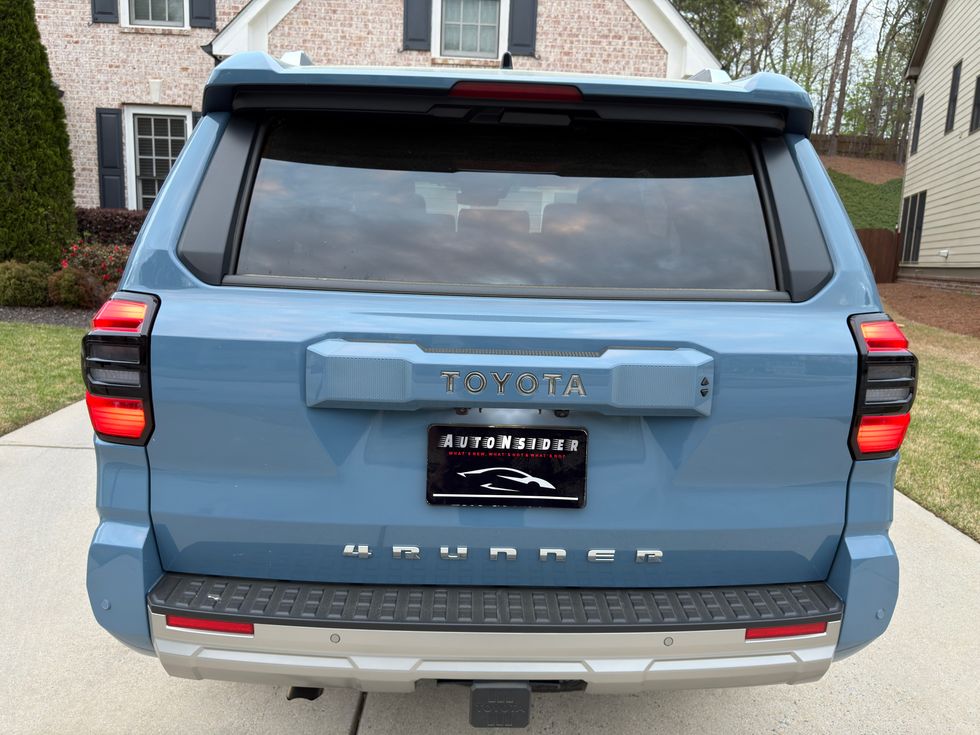 Rear view of a light blue Toyota 4Runner SUV, featuring TOYOTA and 4Runner badges, LED taillights.