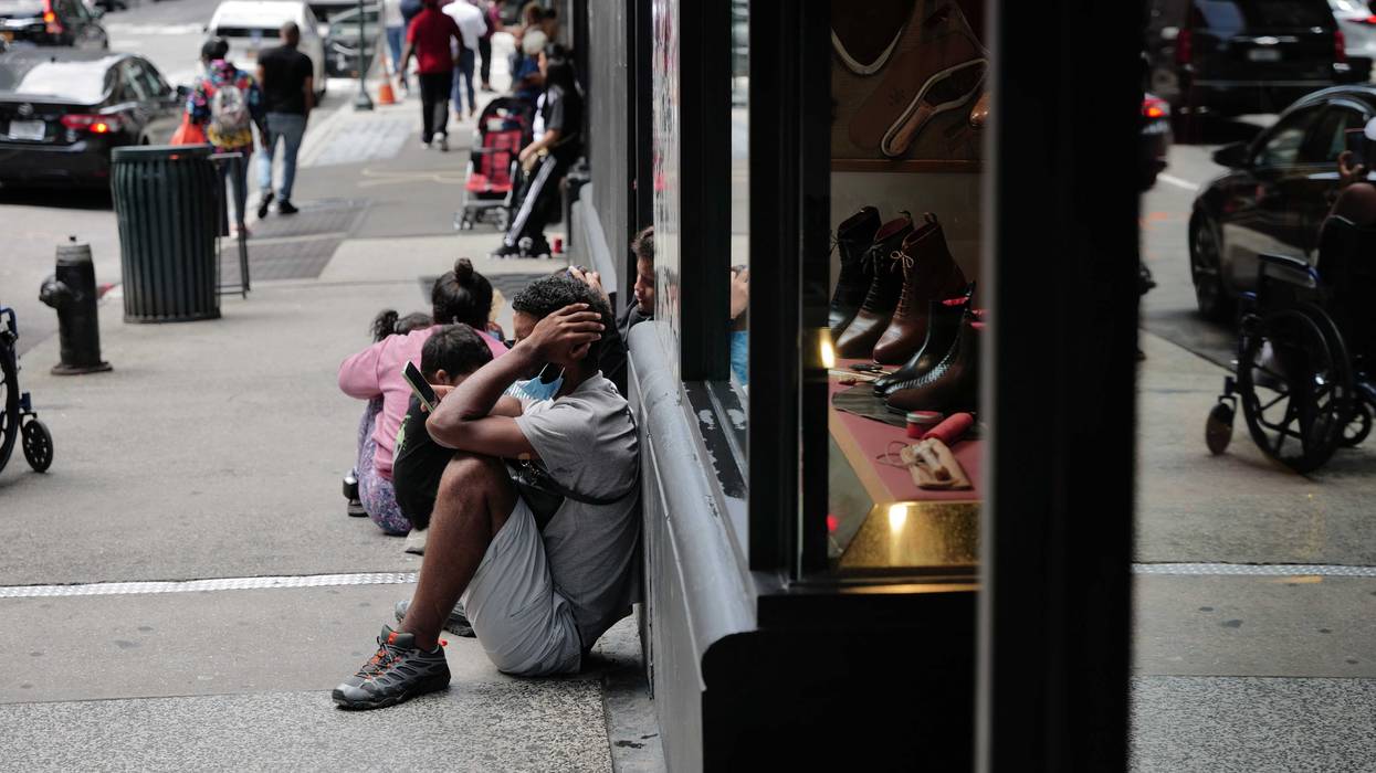 Recently arrived migrants gather outside of the Roosevelt Hotel in New York City on August 14, 2023 in New York City.