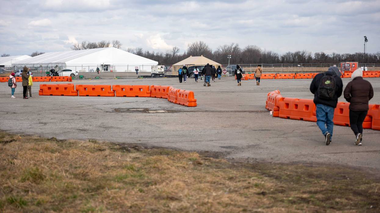 Recently arrived migrants walk from their temporary tent shelters at Floyd Bennett Field on Jan. 4, 2024
