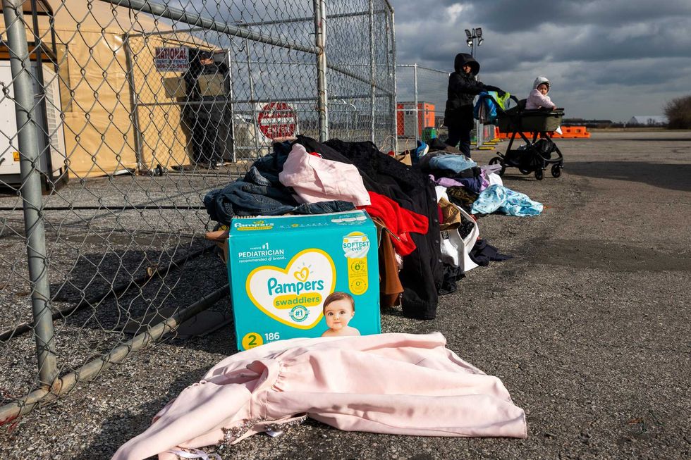Recently arrived migrants walk from their temporary tent shelters at Floyd Bennett Field on Jan. 4, 2024
