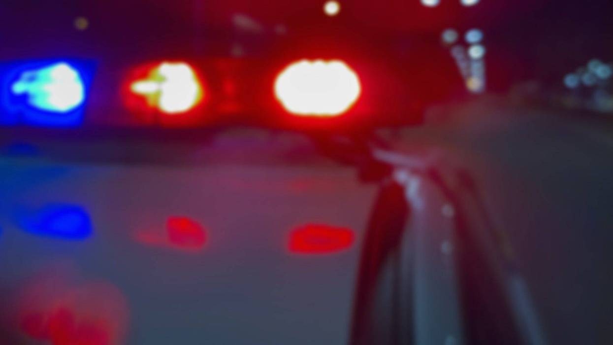 Red and blue flashing police car lights at night