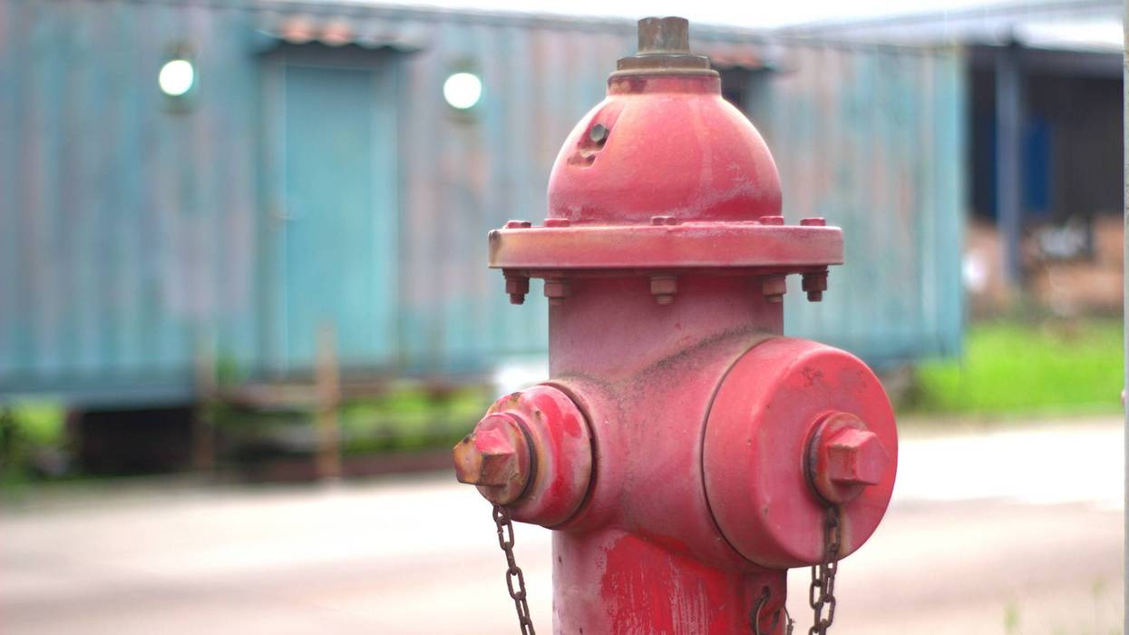 Red fire hydrant close-up outdoors.