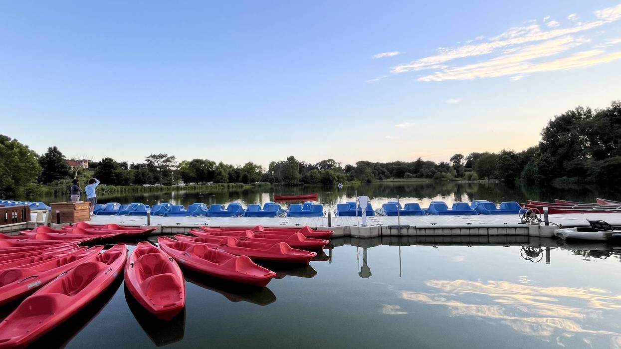 Red kayaks and blue pedal boats docked at the Boathouse in Forest Park in 2024.