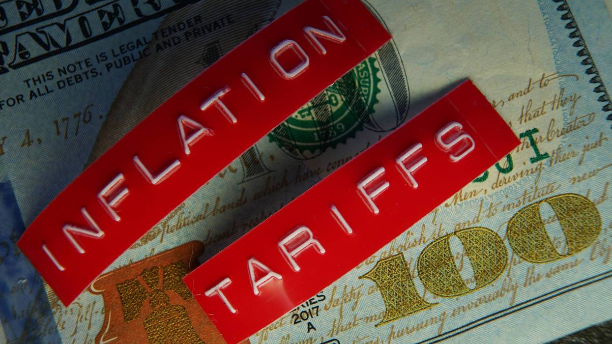 Red Tariffs and Inflation labels on a hundred dollar bill