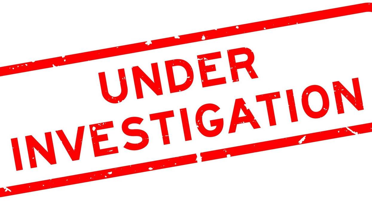 Red under investigation word square rubber seal stamp on white background