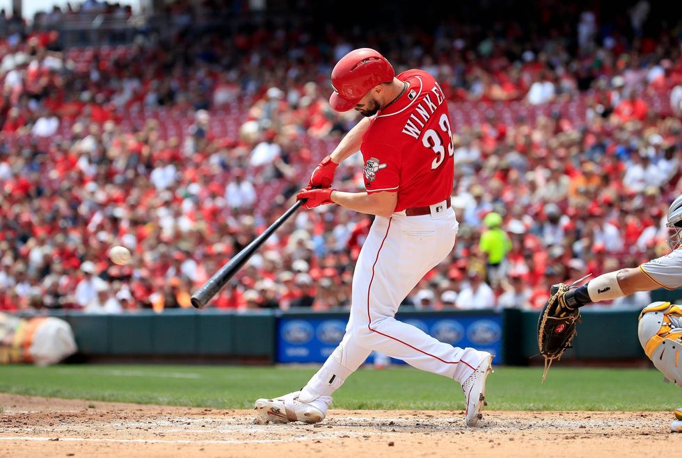 Reds outfielder Jesse Winker connects on a base hit