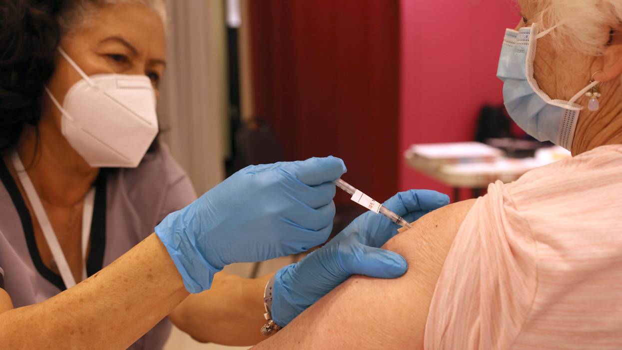 Registered Nurse Orlyn Grace (L) administers a COVID-19 booster vaccination to Jeanie Merriman (R) at a COVID-19 vaccination clinic on April 06, 2022 in San Rafael, California.