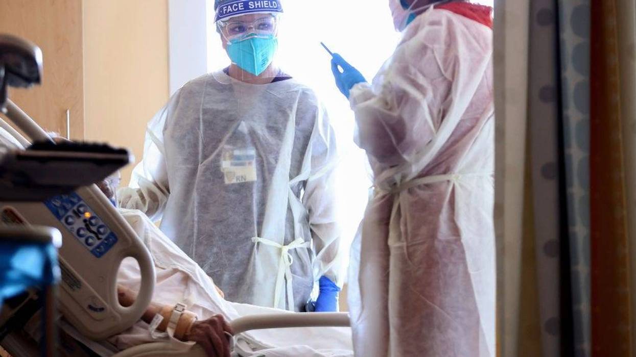Registered nurse (RN) Elle Lauron (C) cares for a COVID-19 patient in the improvised COVID-19 unit at Providence Holy Cross Medical Center in the Mission Hills neighborhood on July 30, 2021, in Los Angeles, California.