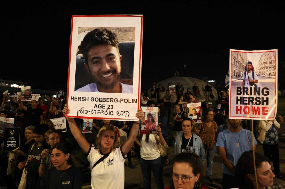 Relatives and supporters raise placards bearing portraits of Israeli hostage Hersh Goldberg-Polin, 23, and other hostages held in Gaza since the October 7.