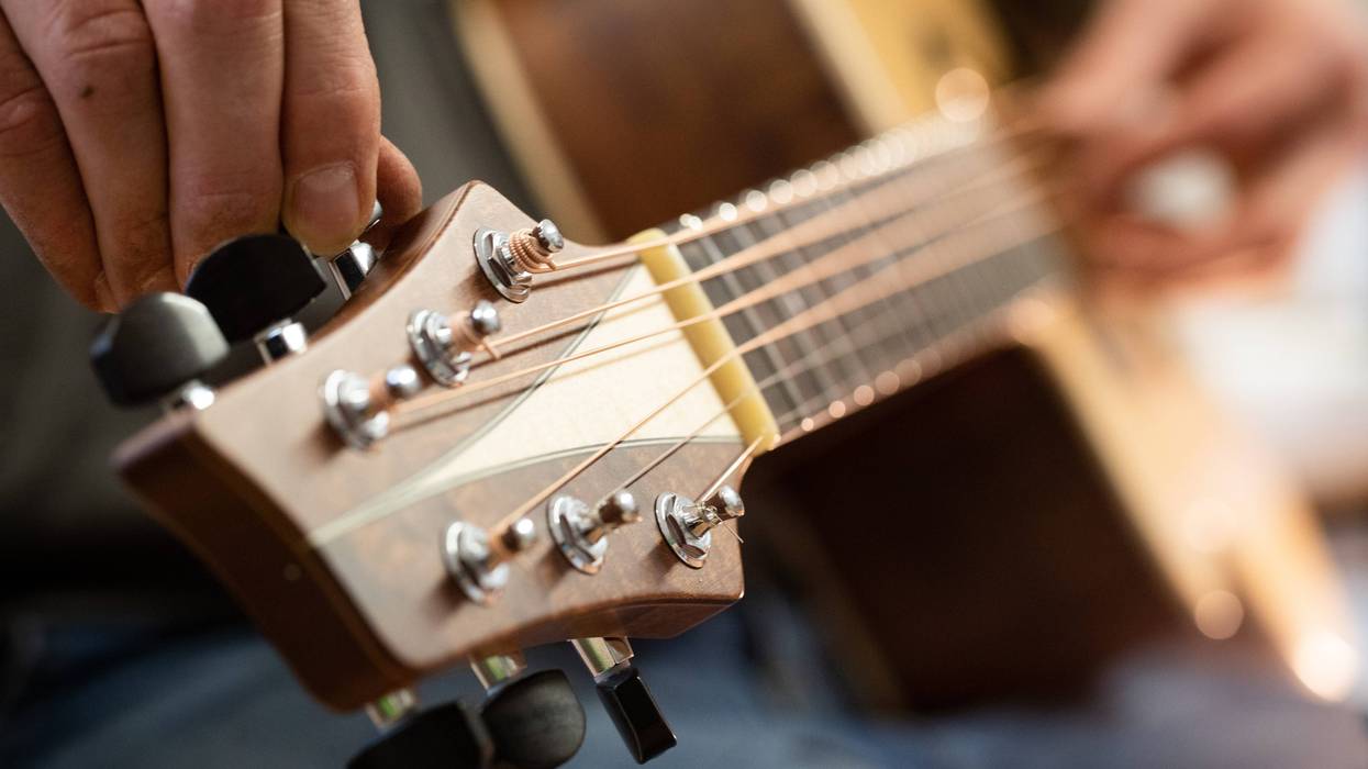 REMAGEN, GERMANY - DECEMBER 11: Master guitar craftsman Tobias Ahlke adjusts the tones on an acoustic guitar body at his workshop on December 11, 2019 in Remagen, Germany. Germany. Ahlke produces acoustic and electric guitars from carefully selected types