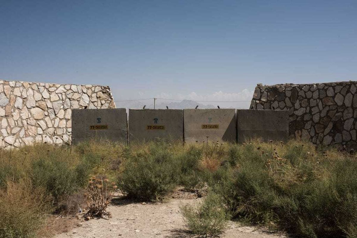 Remnants of dilapidated buildings sit at an unused section of Bagram Air Field