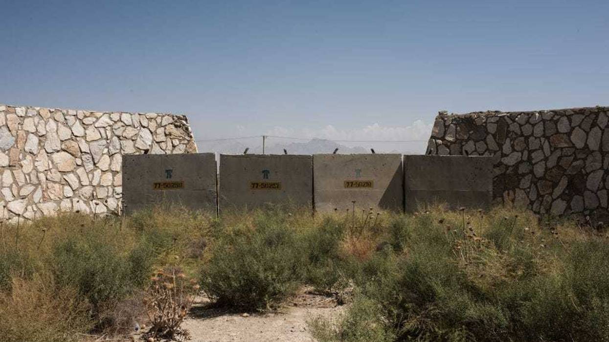 Remnants of dilapidated buildings sit at an unused section of Bagram Air Field