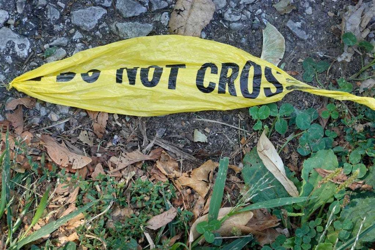 Remnants of police crime scene tape remain near the site where two young girls were shot after leaving their grandmother's home yesterday on August 16, 2021 in Chicago, Illinois. The two girls were shot as their mother was buckling them in her vehicle. Seven-year-old Serenity Broughton died from her injuries. Broughton's 6-year-old sister Aubrey was seriously wounded and remains in the hospital following the shooting, which occurred on August 15. (Photo by Scott Olson/Getty Images)