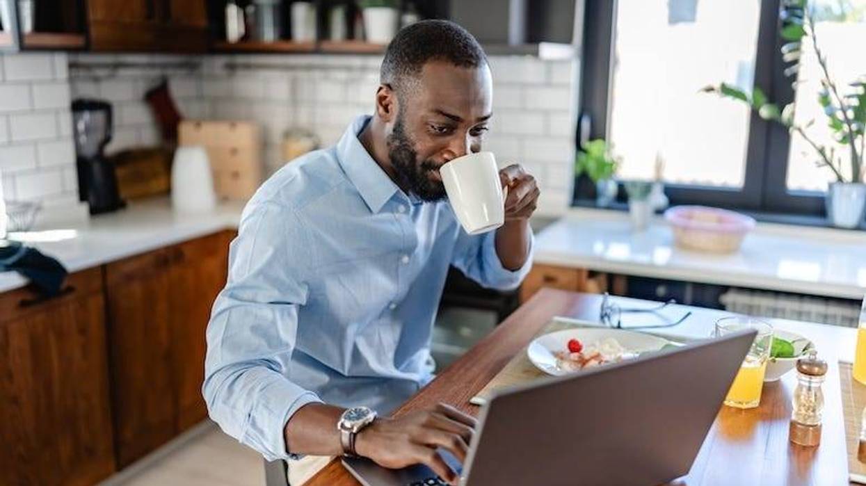 Remote worker on his computer in the kitchen
