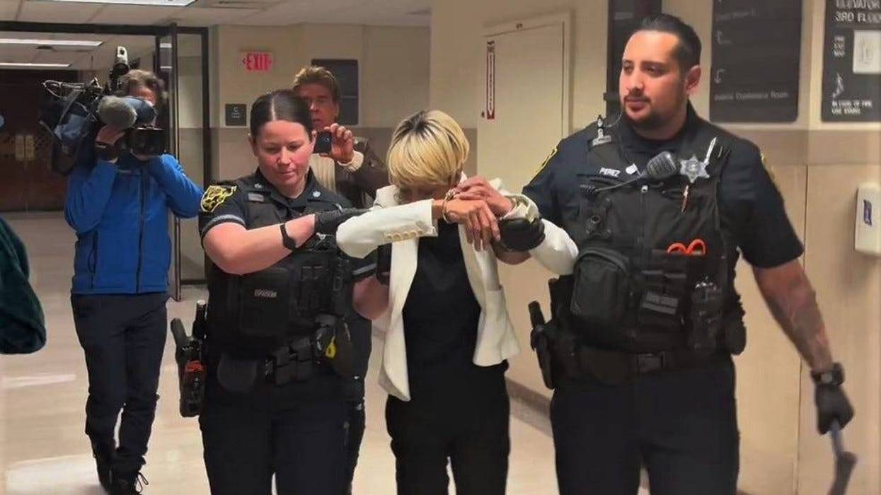 Renee DiPietro is led away from the courtroom by officers.