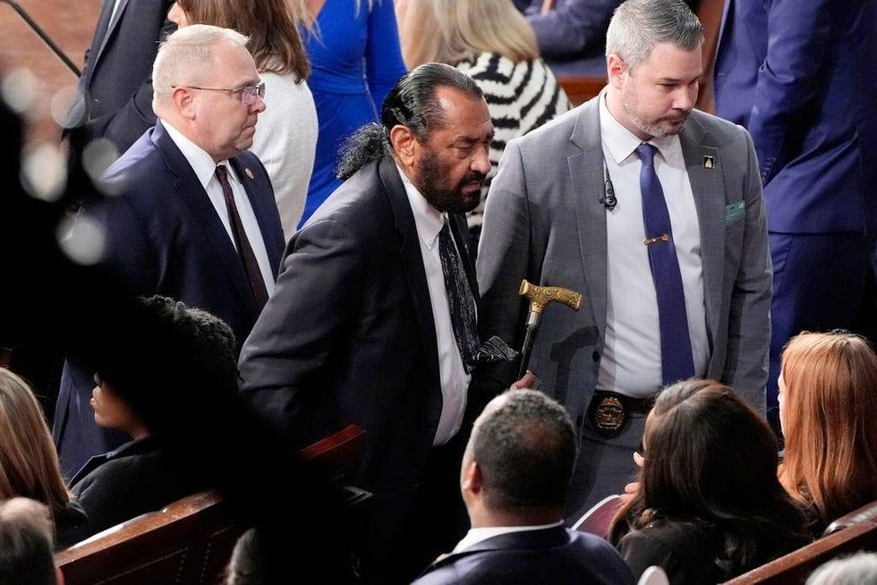 Rep. Al Green, D-Texas, center, is escorted out as President Donald Trump addresses a joint session of Congress at the Capitol in Washington, Tuesday, March 4, 2025.