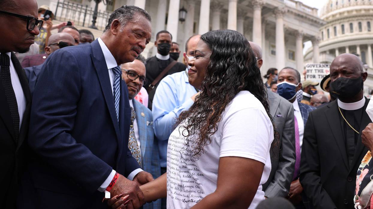 Rep. Cori Bush (D-MO) (R) holds hands with civil rights activist Jesse Jackson, as they rally against the end of the eviction moratorium at the U.S. Capitol on August 03, 2021 in Washington, DC. Bush, and other Representatives, have been sleeping on and occupying the House steps in protest of their House colleagues adjourning for August recess without passing an extension of the eviction moratorium.