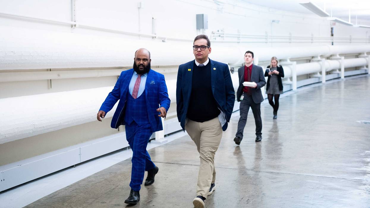 Rep. George Santos, R-N.Y., center, walks through the Cannon tunnel from the U.S. Capitol on Feb. 8, 2023