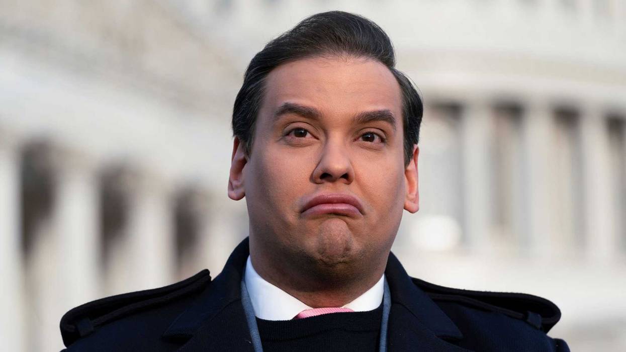 Rep. George Santos, R-N.Y., faces reporters at the Capitol in Washington, early Thursday, Nov. 30, 2023