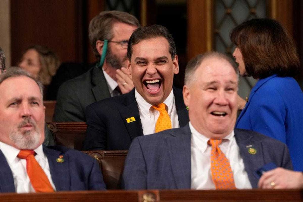 Rep. George Santos (R-NY) (C) laughs before U.S. President Joe Biden delivers the State of the Union address to a joint session of Congress on February 7, 2023 in the House Chamber of the U.S. Capitol in Washington, DC. The speech marks Biden's first address to the new Republican-controlled House. (Photo by Jacquelyn Martin-Pool/Getty Images)